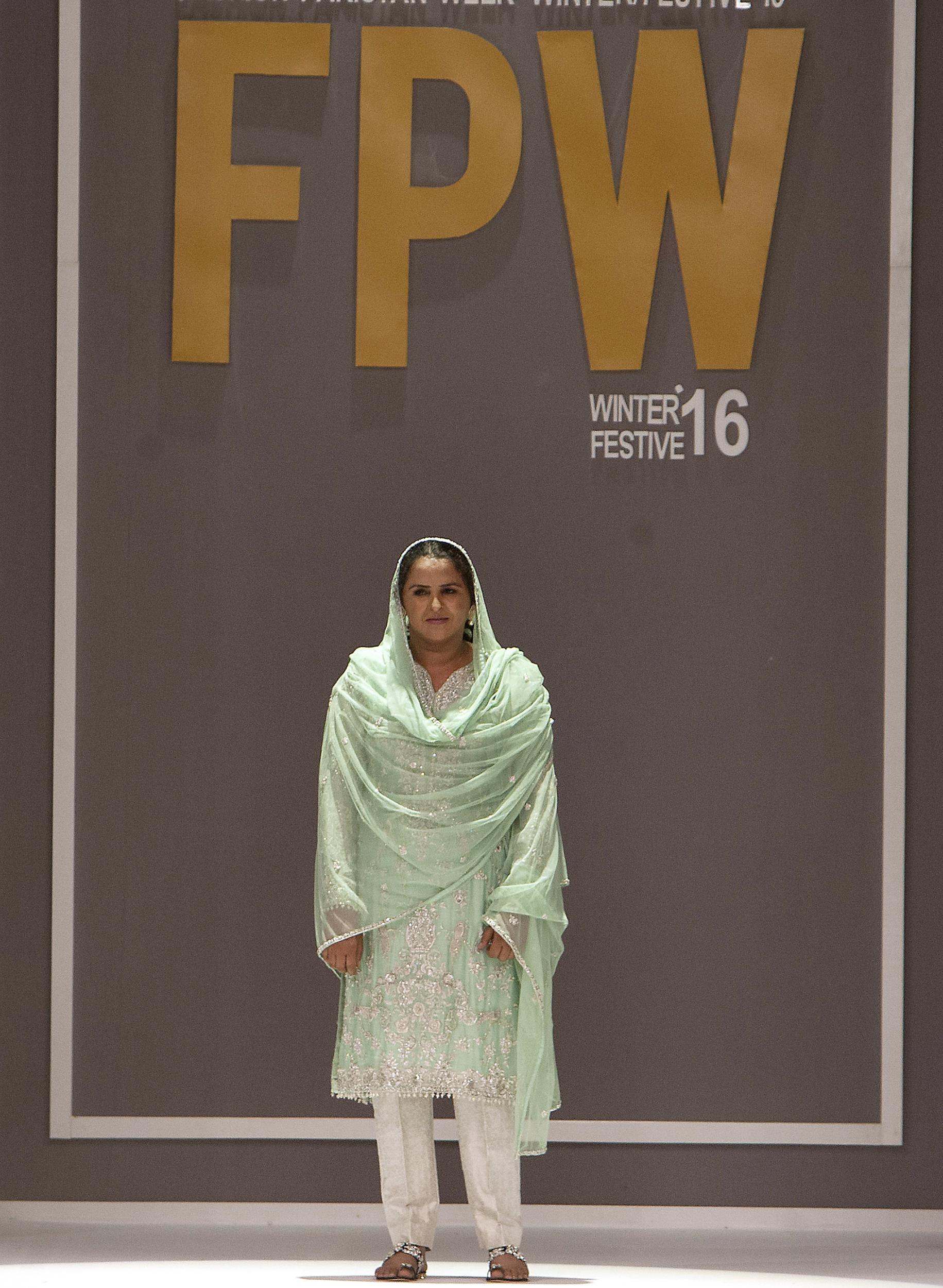 Gang-raped and paraded naked 14-years ago, Mukhtar Mai walked on during Pakistan fashion week on Tuesday