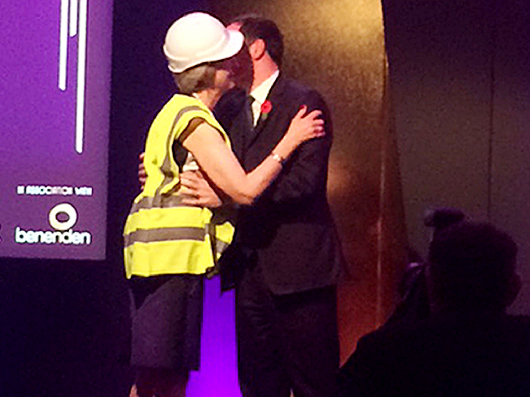 Prime Minister Theresa May who appeared to mock George Osborne by accepting an award from the former chancellor wearing a high-visibility jacket and hard hat