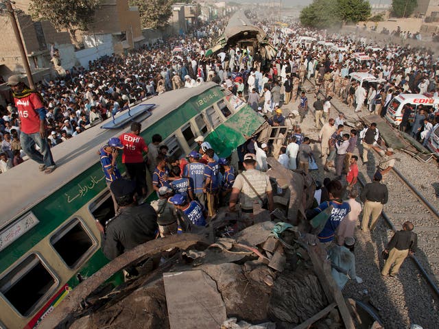 Rescuers search for victims in the wreckage of the trains in Karachi