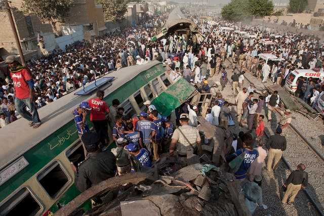 Rescuers search for victims in the wreckage of the trains in Karachi