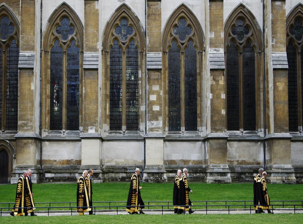 Justices of the Supreme Court of the United Kingdom arrive at Westminster Abbey after being sworn in at the Middlesex Guildhall in Parliament Square in London