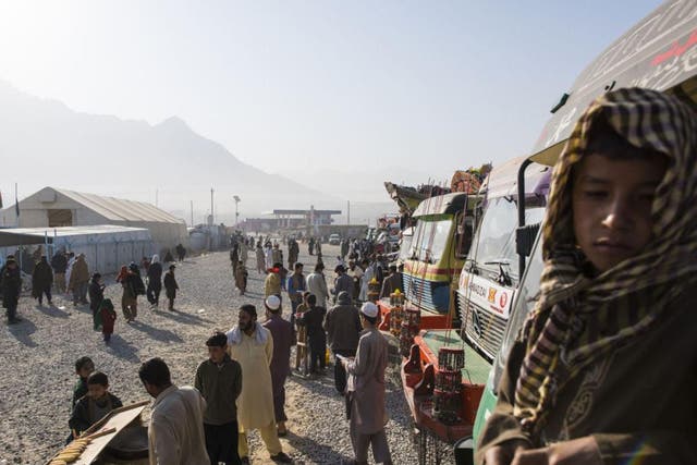 Families wait outside for a UN ‘encashment’ centre to open last month on the outskirts of Kabul. Afghan returnees are provided with health checks, immunisations and needs assessments