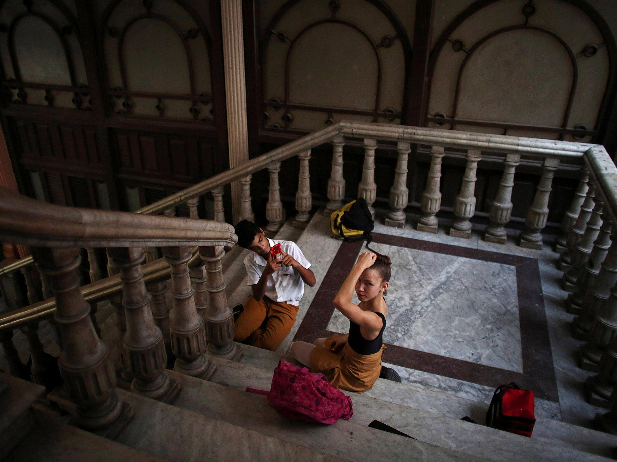 Students at the Cuba's National Ballet School (ENB) play with a cell phone during a break in Havana, Cuba