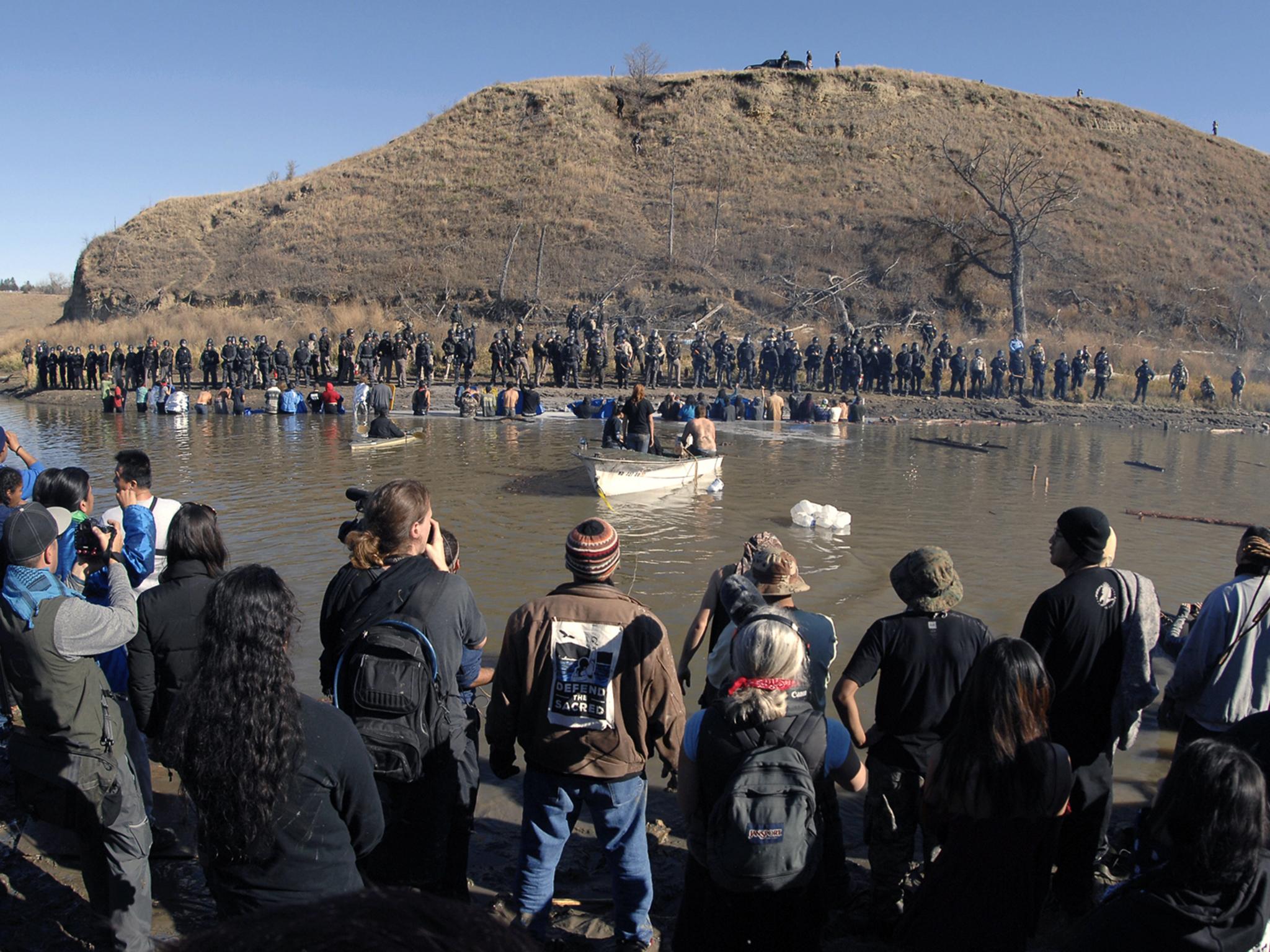 Protesters waded through the water trying to reach property owned by the pipeline’s developer