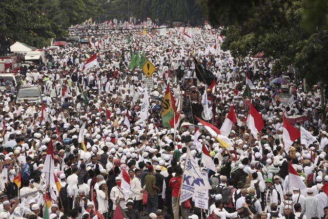 Muslim protesters march during a demonstration in Jakarta to demand the arrest of its minority-Christian governor for alleged blasphemy