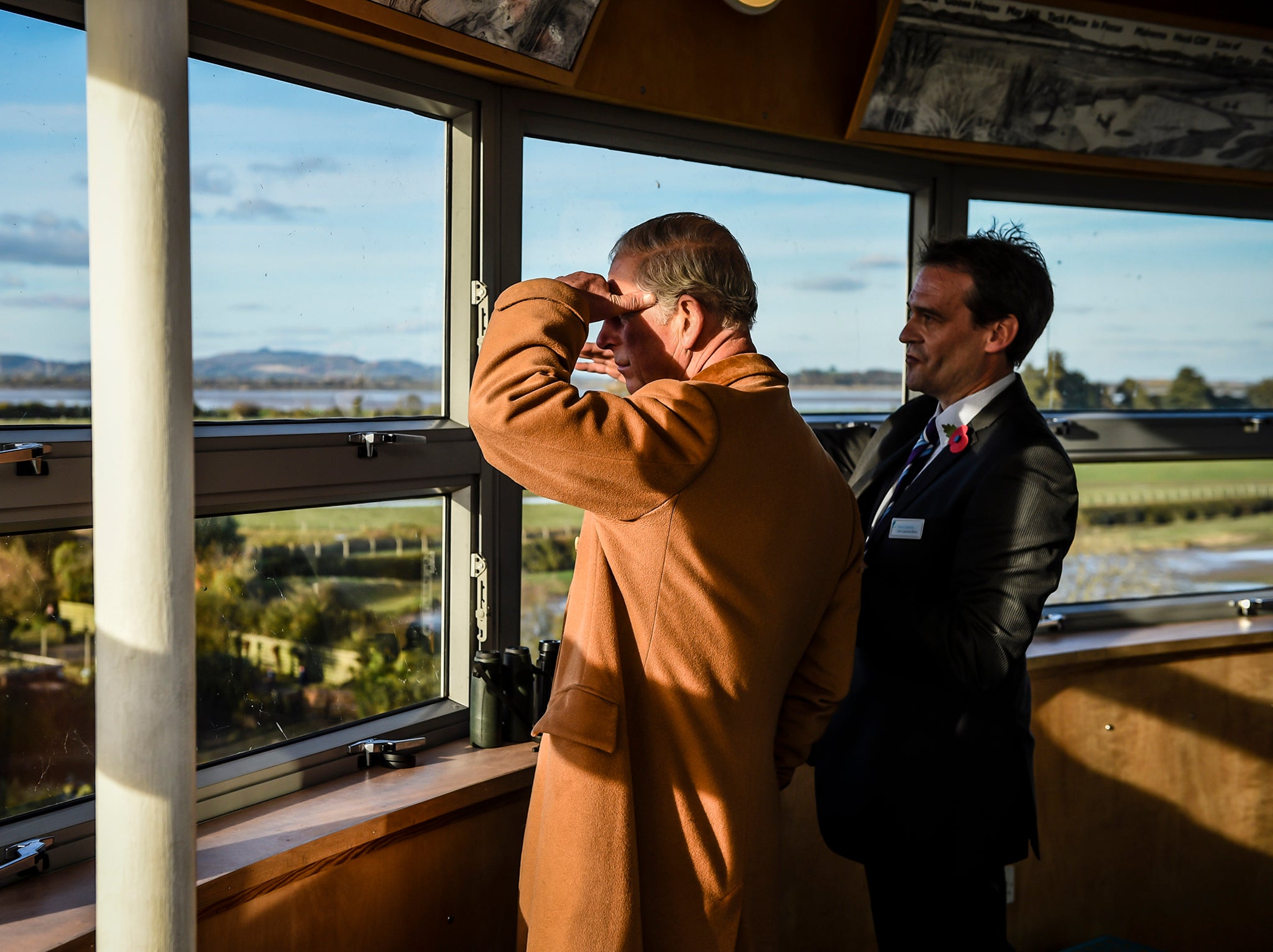 The Prince of Wales looks out from the observation tower during a visit to the Wildfowl and Wetlands Trust's Slimbridge Wetland Centre in Gloucestershire
