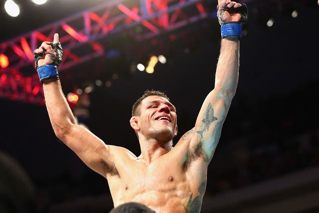 Rafael dos Anjos celebrates his win against Anthony Pettis in the Lightweight Title bout during the UFC 185