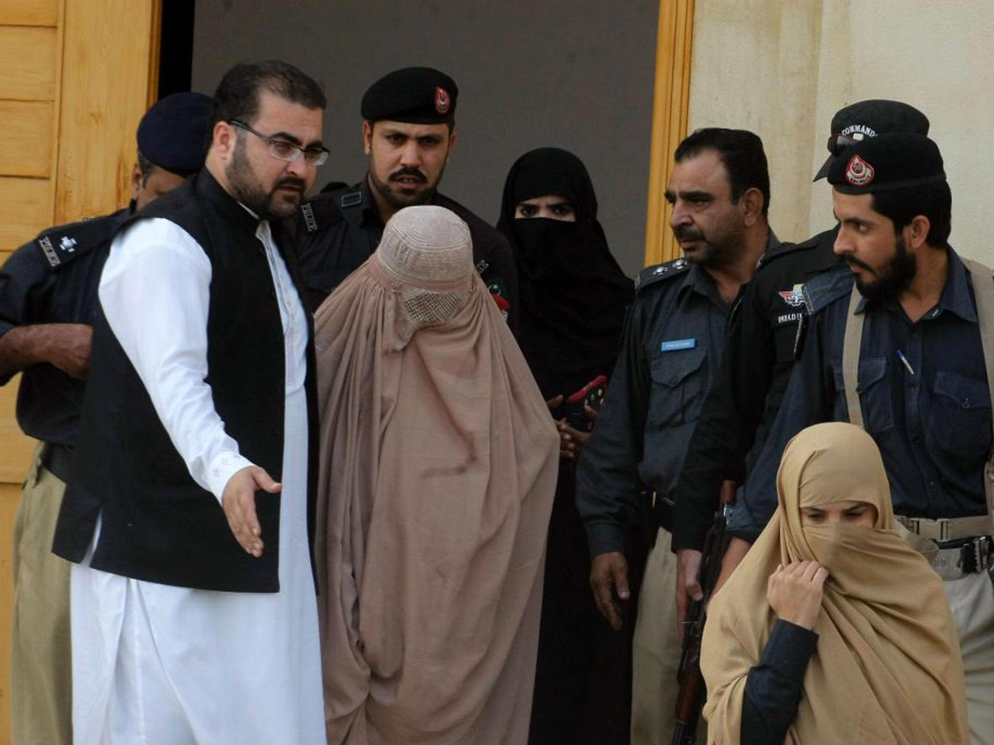 Sharbat Gula (C) leaves the court in Peshawar