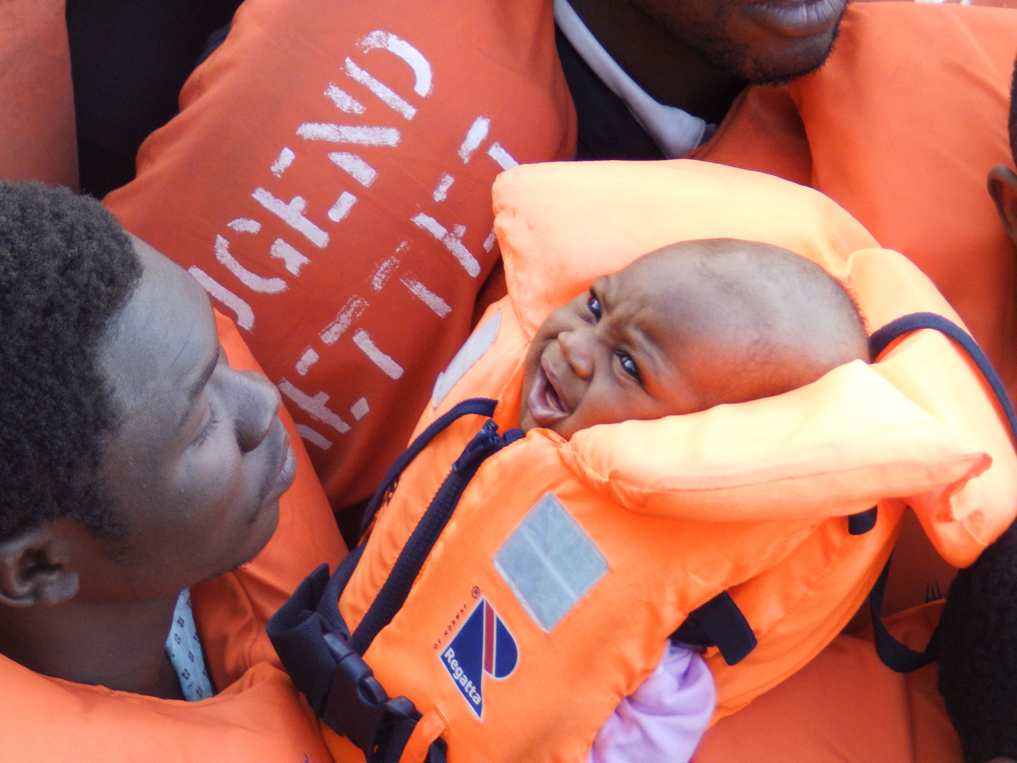 A baby among refugees on a boat carrying 185 people off the coast of Libya