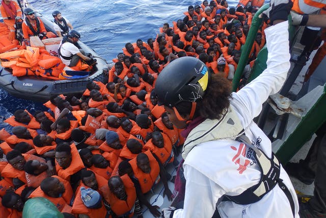 MSF cultural mediator Luwam Bede talking to refugees on a boat carrying 185 people