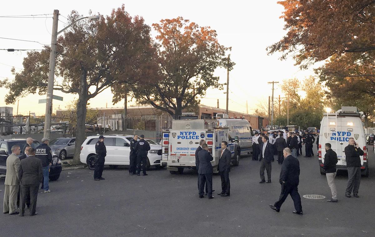New York City Police Officers gather at a shooting scene in the Bronx borough of New York, Friday, Nov. 4, 2016. say two New York City police sergeants were shot, one fatally, in a gun battle with a home invasion suspect. A police spokesman says the robbery suspect was killed in the gun fire exchange.