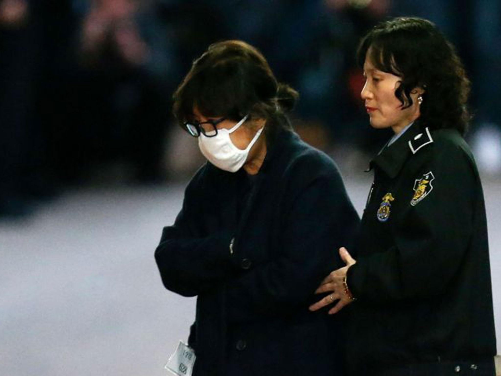 Choi Soon-Sil (L) is escorted from the Central District Court in Seoul following her arrest (AFP/Getty)