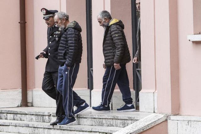 Two Italian hostages who were kidnapped in Southern Libya, Bruno Cacace (L) and Danilo Calonego (R) leave a police station after being debriefed