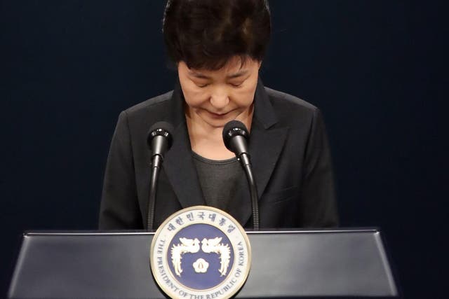 South Korean President Park Geun-hye bows in apology as she delivers an address to the nation about the scandal