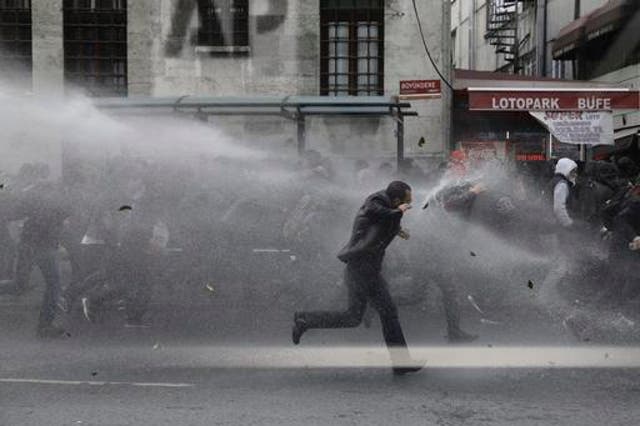 Riot police use water cannons to disperse people protesting the detentions of 12 lawmakers from pro-Kurdish Peoples' Democratic Party