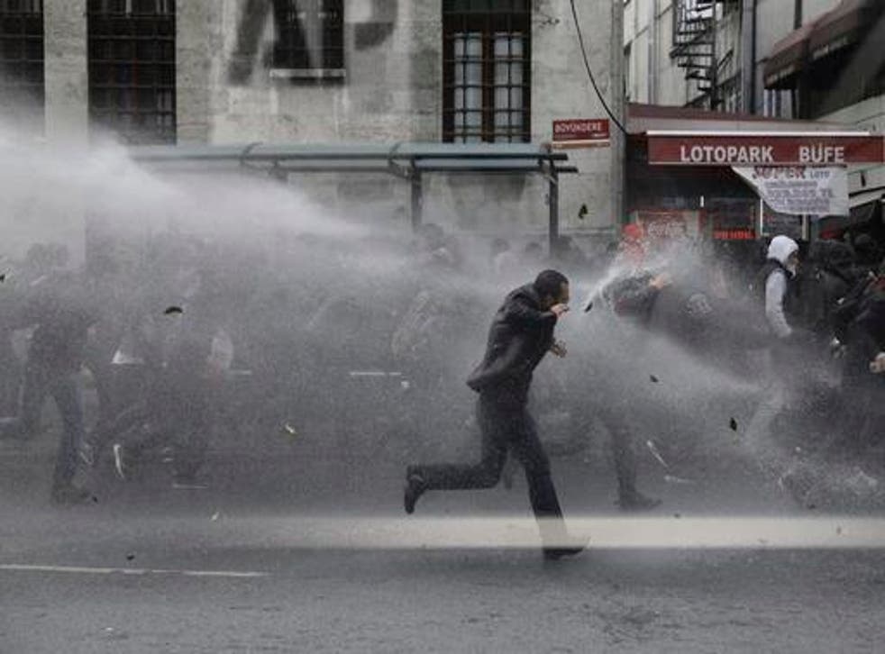 Riot police use water cannons to disperse people protesting the detentions of 12 lawmakers from pro-Kurdish Peoples' Democratic Party