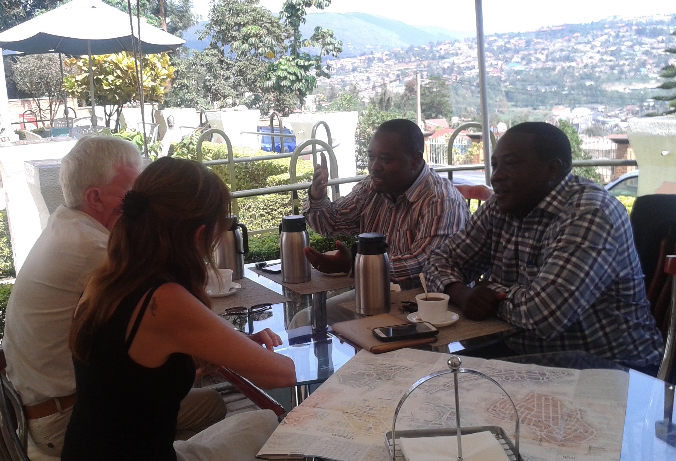 Wendy Murphy and her husband Tim (far left) meet with JMV Gatabazi MP (far right) and another Rwandan official in Kigali