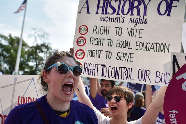 Abortion rights activists cheer after the US Supreme Court struck down a Texas law placing restrictions on abortion clinics