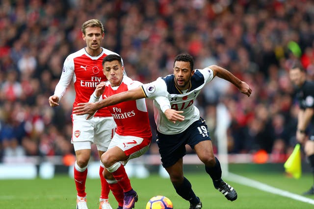 Mousa Dembele and Alexis Sanchez vie for the ball early on in the game