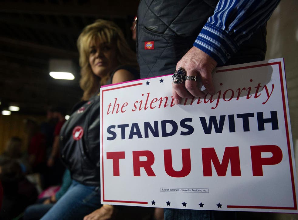 A supporter of Trump, wearing a US flag ring, listens as Trump addresses a capacity crowd at the National Western Complex in Denver, Colorado