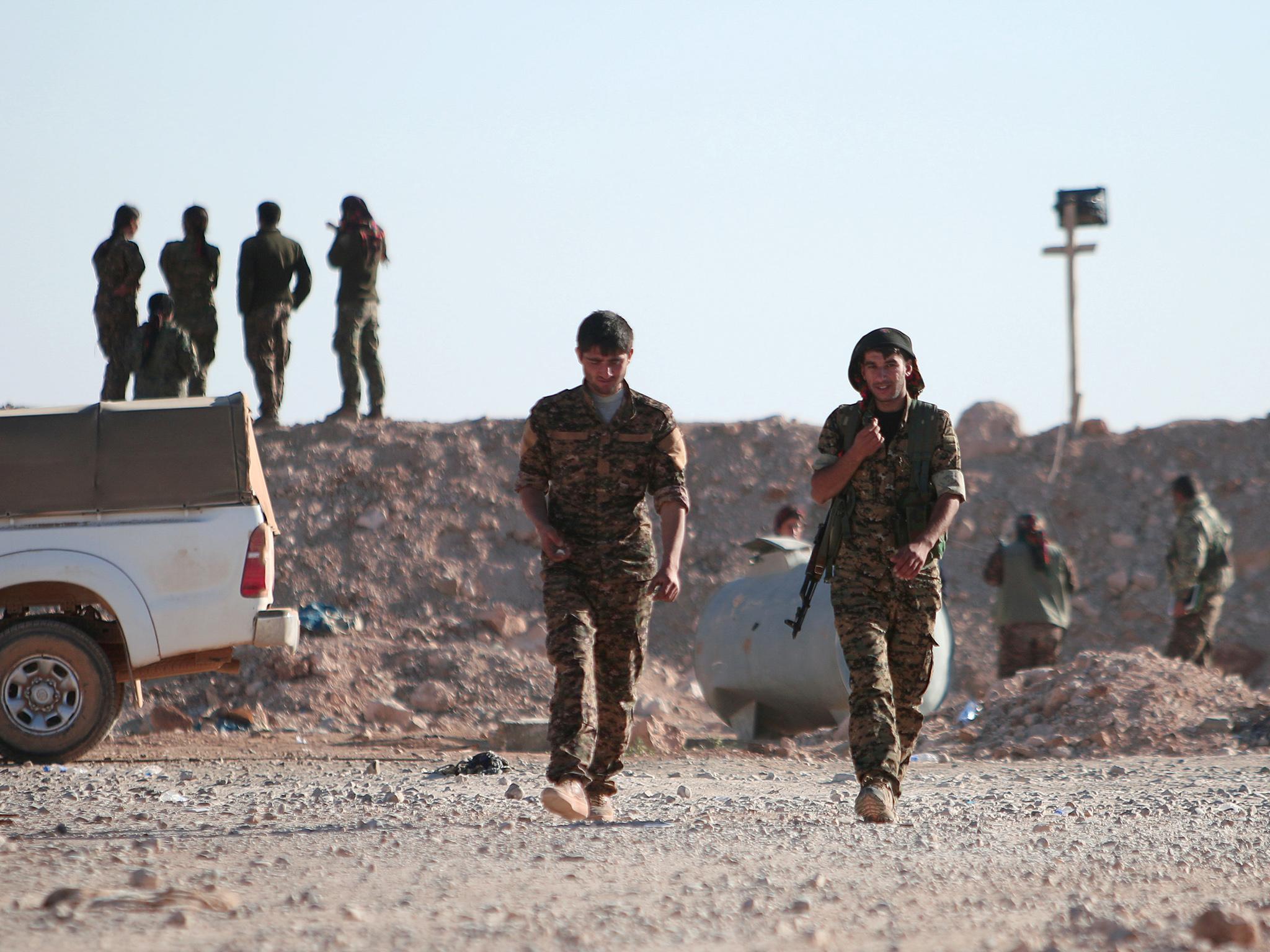 SDF fighters pictured near Raqqa. Fierce coalition air strikes are designed to assist their ground assault on the city