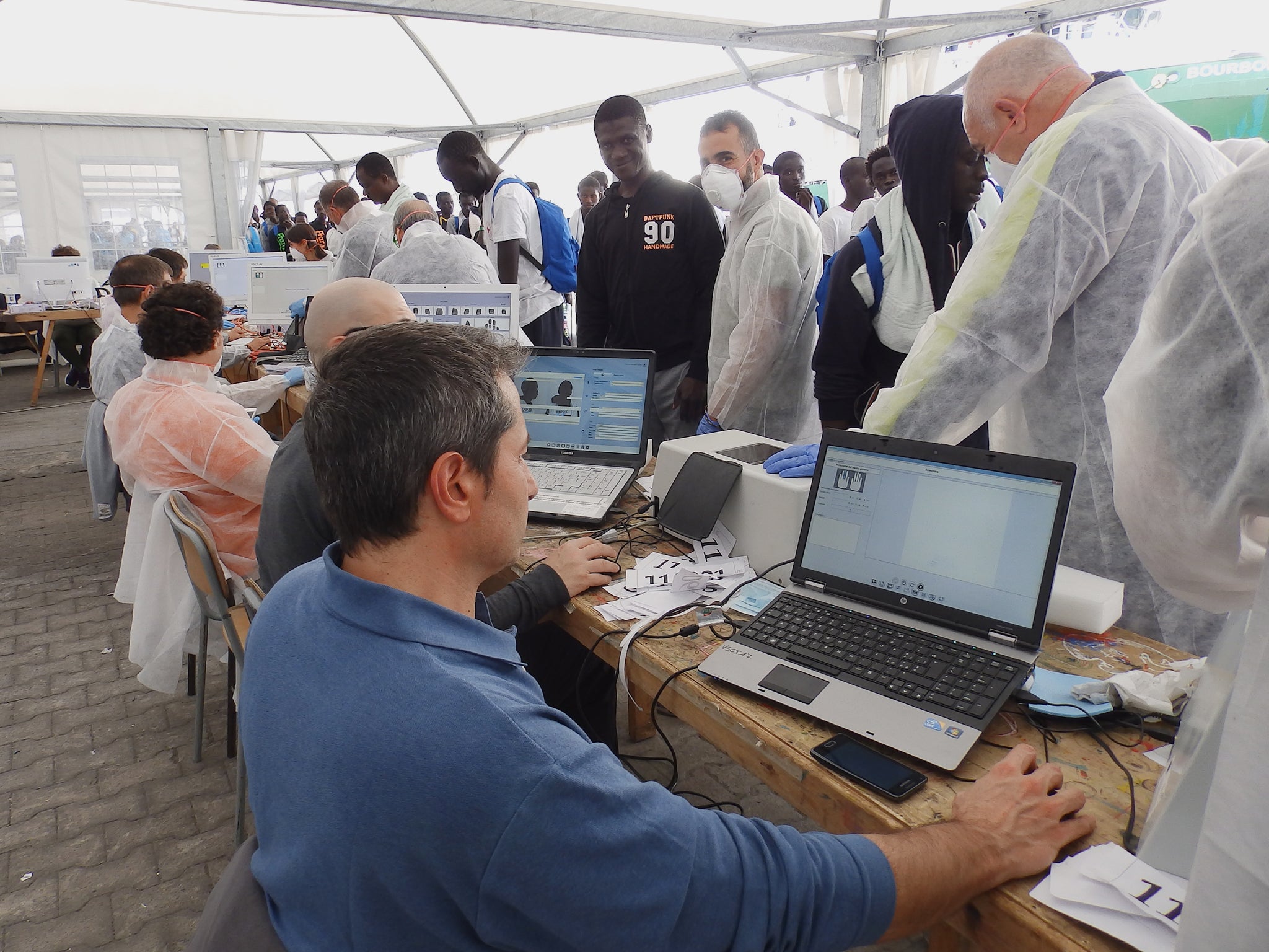 &#13;
People are fingerprinted after disembarking from MSF rescue ships, as seen here in Catania, Sicily &#13;