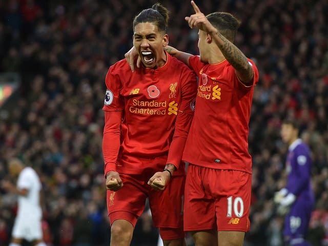 Roberto Firmino and Philippe Coutinho celebrate the former scoring in the 6-1 demolition of Watford