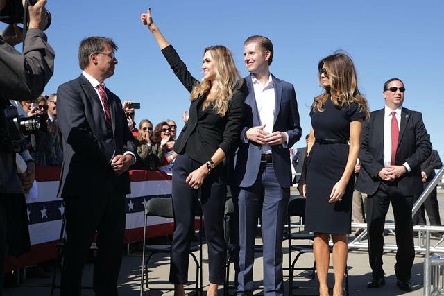 Lara Trump, left, beside Eric and Melania Trump