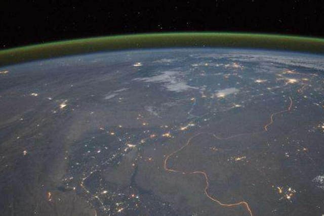 Nighttime panorama showing Pakistan’s Indus River valley, taken from space. The green band above the horizon is airglow