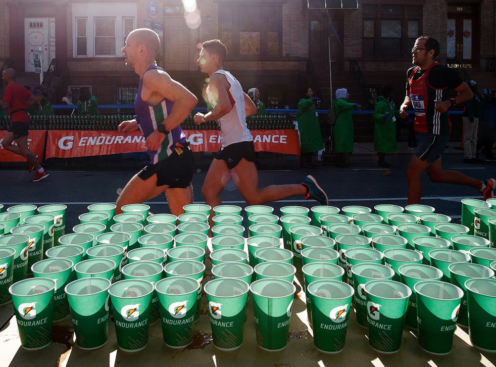 Runners pass a hydration station