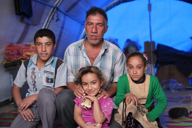 Karim, pictured with three of his five children, fled the fighting south of Mosul city when the offensive to take the city back from Isis began a few weeks ago
