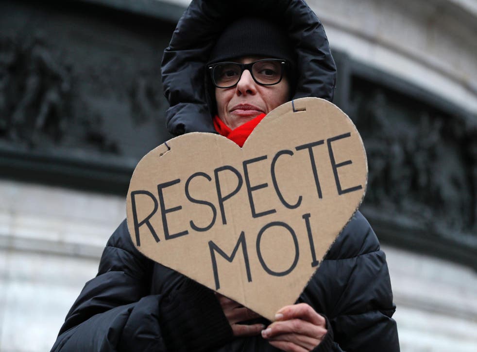 A woman carries a sign reading 'Respect Me' during a demonstration for equal pay between men and women on November 7, 2016, at Place de la Republique in Paris