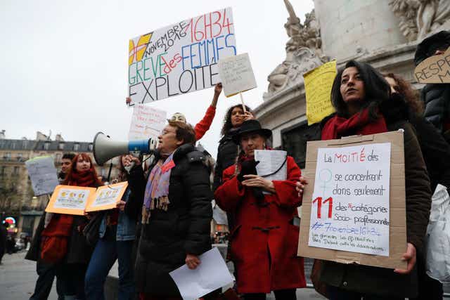 Protestors carry signs and chant slogans during a demonstration for equal pay on November 7, 2016, at Place de la Republique in Paris
