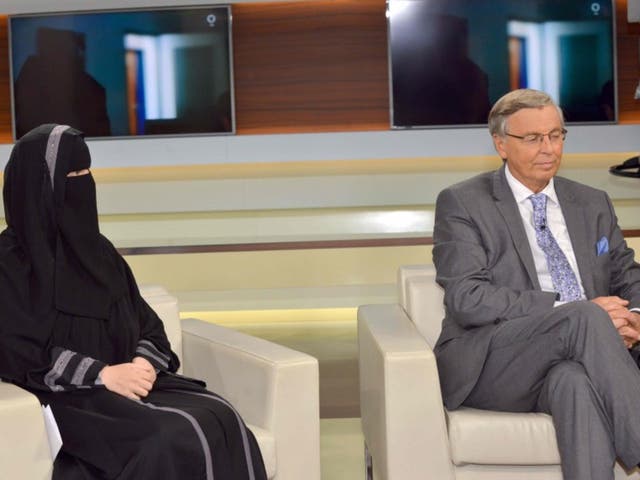 Nora Illi, the women's representative of an unofficial group called the Islamic Central Committee of Switzerland, wears a niqab Sunday night on a talk show in Berlin. Next to her is Wolfgang Bosbach, a lawmaker from Chancellor Angela Merkel's Christian Democratic Union party