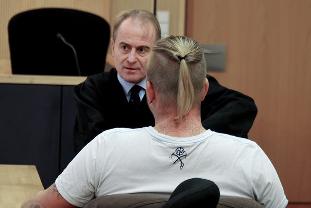 Far-right politician Marcel Zech is waiting for the beginning of the appeal case with his lawyer Wolfram Nahrath, rear, at a courtroom in Neuruppin, Germany