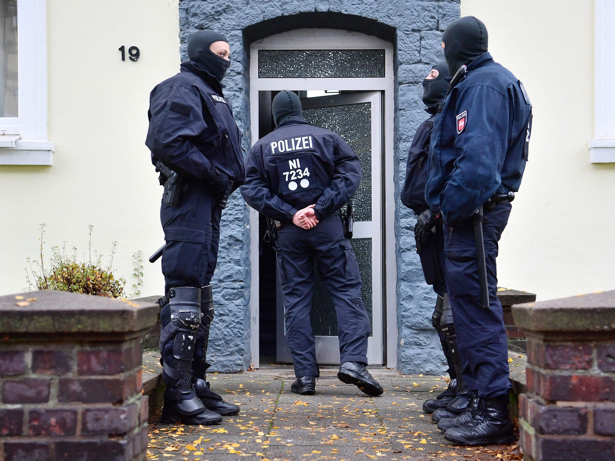 Police officers search a home opposite the German-Speaking Islamic Circle Hildesheim mosque in Hildesheim, Germany, 8 November 2016.