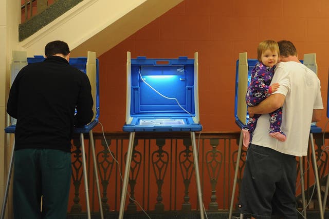 A toddler looks on as people vote in the 2016 Presidential elections at the Alton City Hall on November 8, 2016 in Alton, Illinois