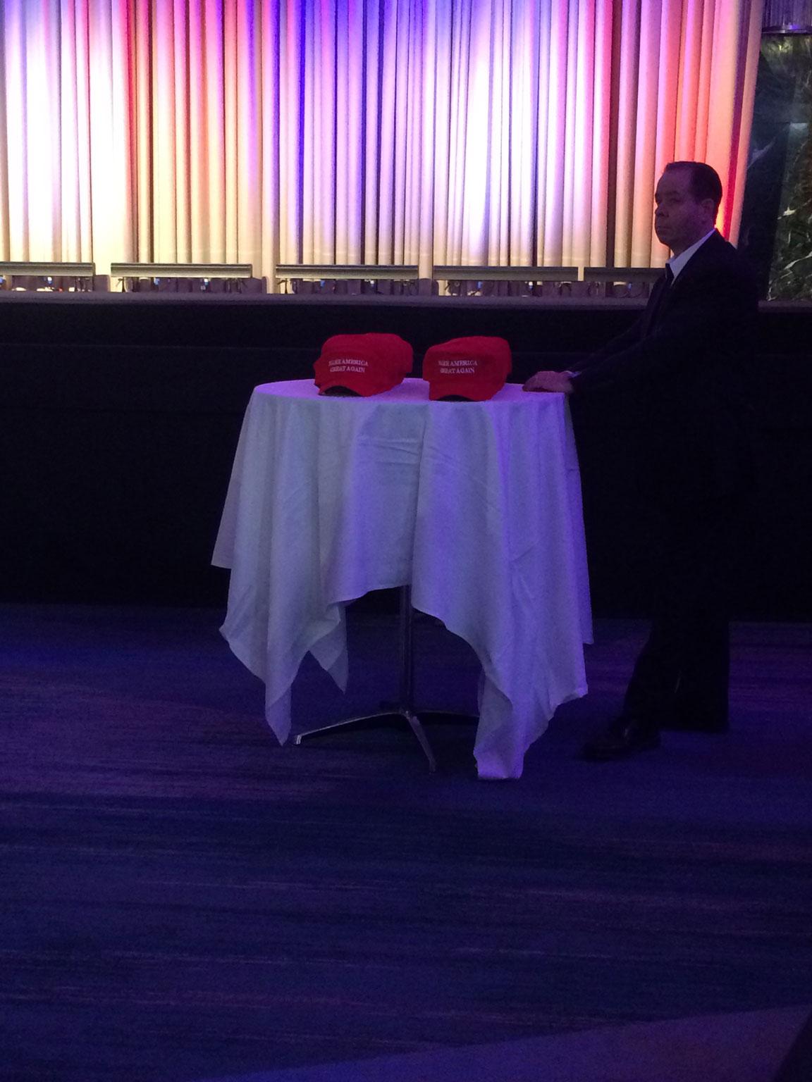 A man accompanies a table of hats before the party built momentum