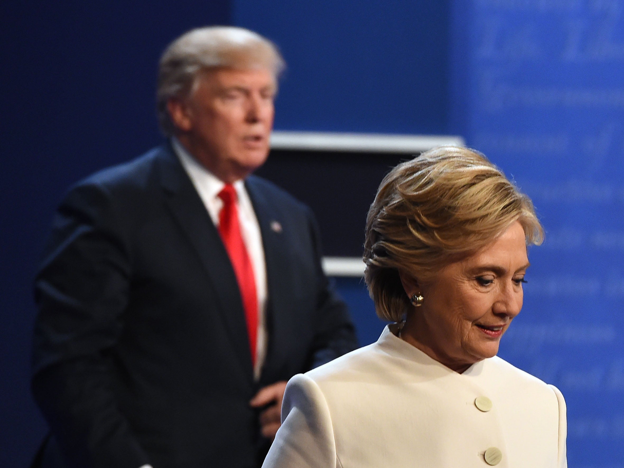 Donald Trump and Hillary Clinton leave the stage after the final presidential debate on 19 October