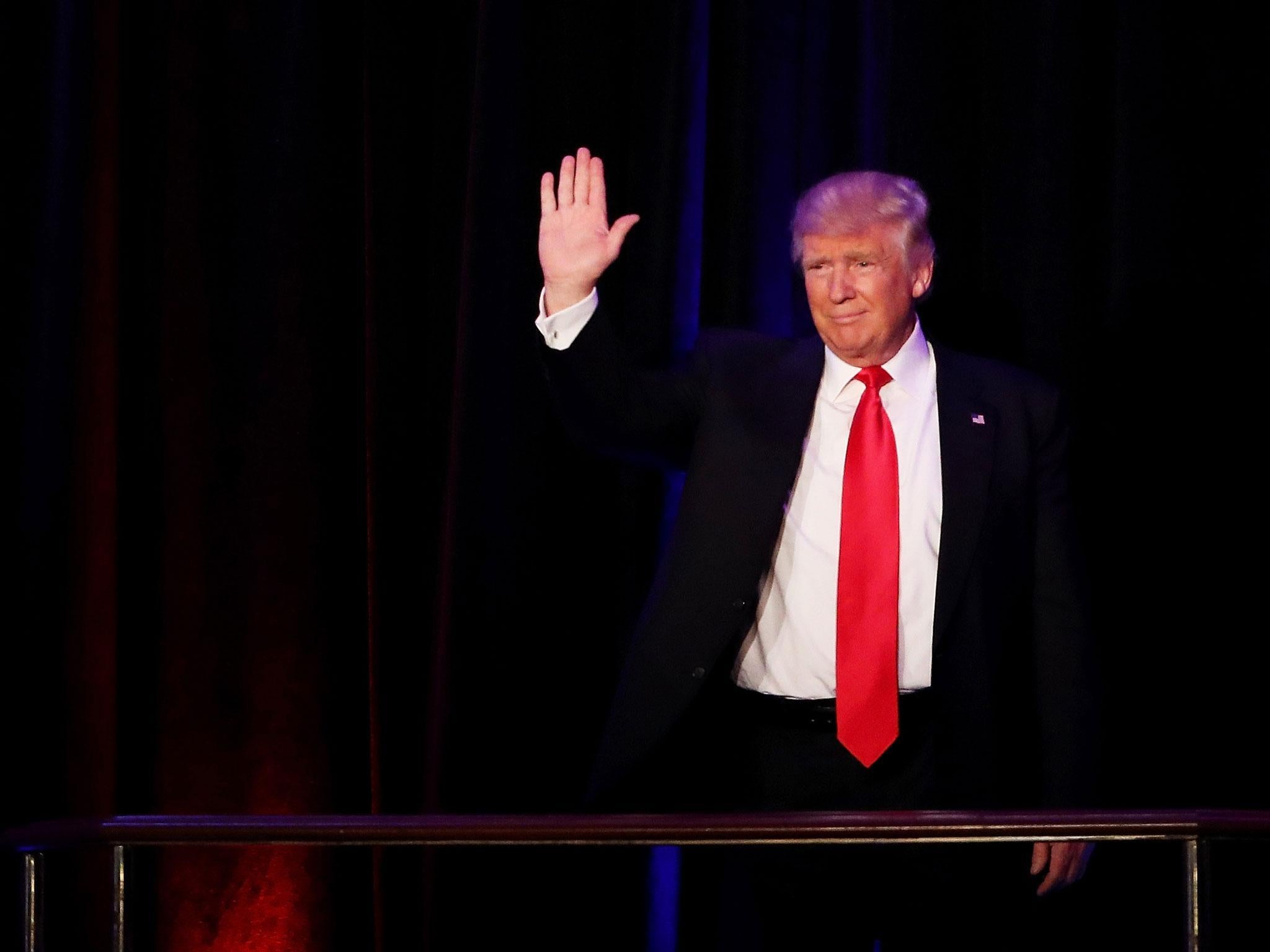 Trump waves to his supporters after Vice President-elect Mike Pence introduces him Getty