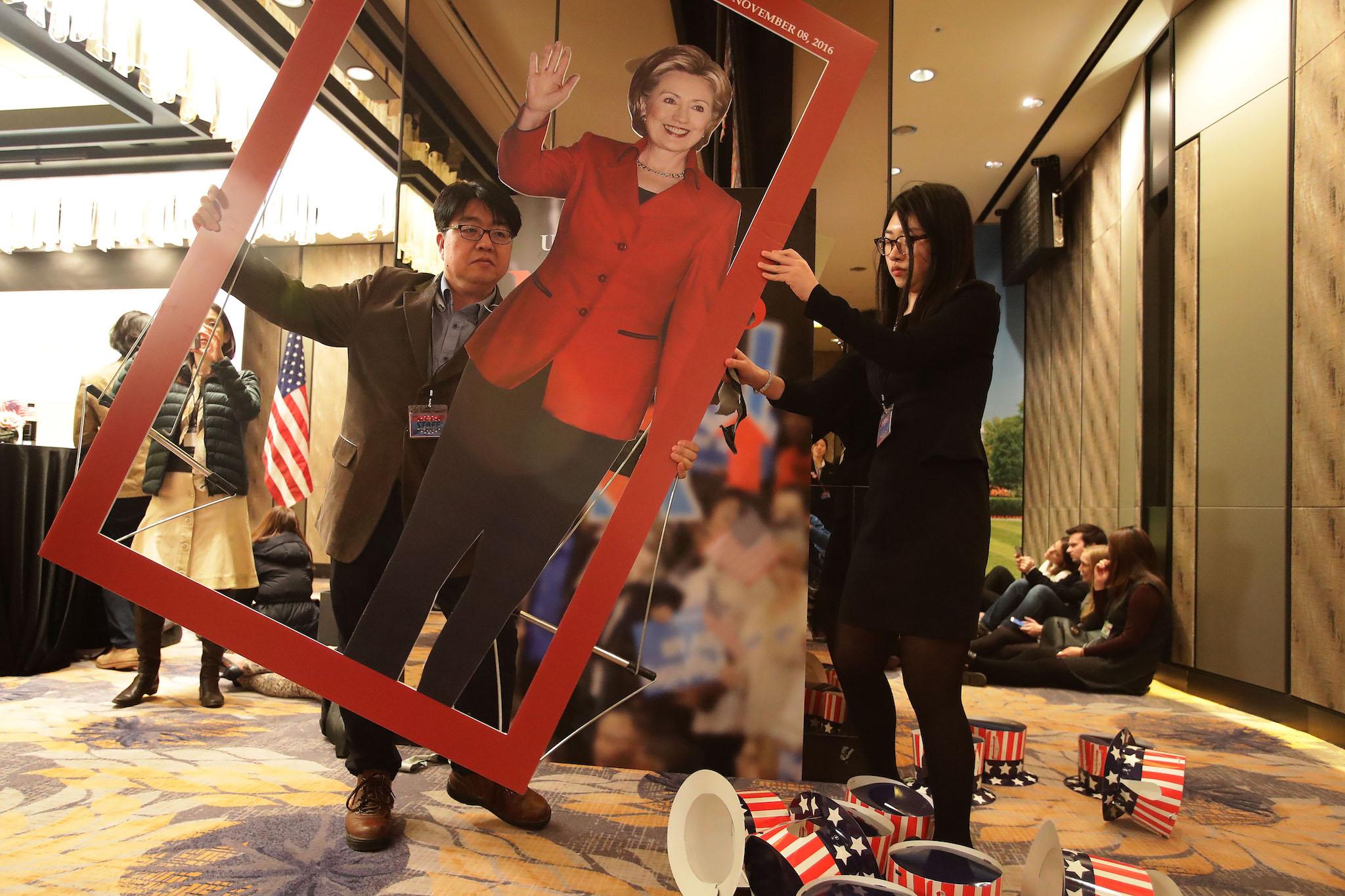 People carrie a picture of Democratic presidential candidate Hillary Clinton after a election watch event on November 9, 2016 in Seoul, South Korea