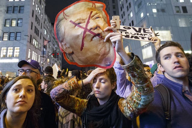 Thousands of anti-Trump demonstrators protest outside Trump Tower after marching from Union Square in New York City