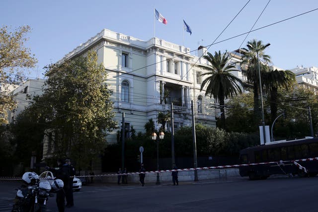 Police stand outside the French embassy in Athens, where unidentified attackers threw an explosive device causing a small blast