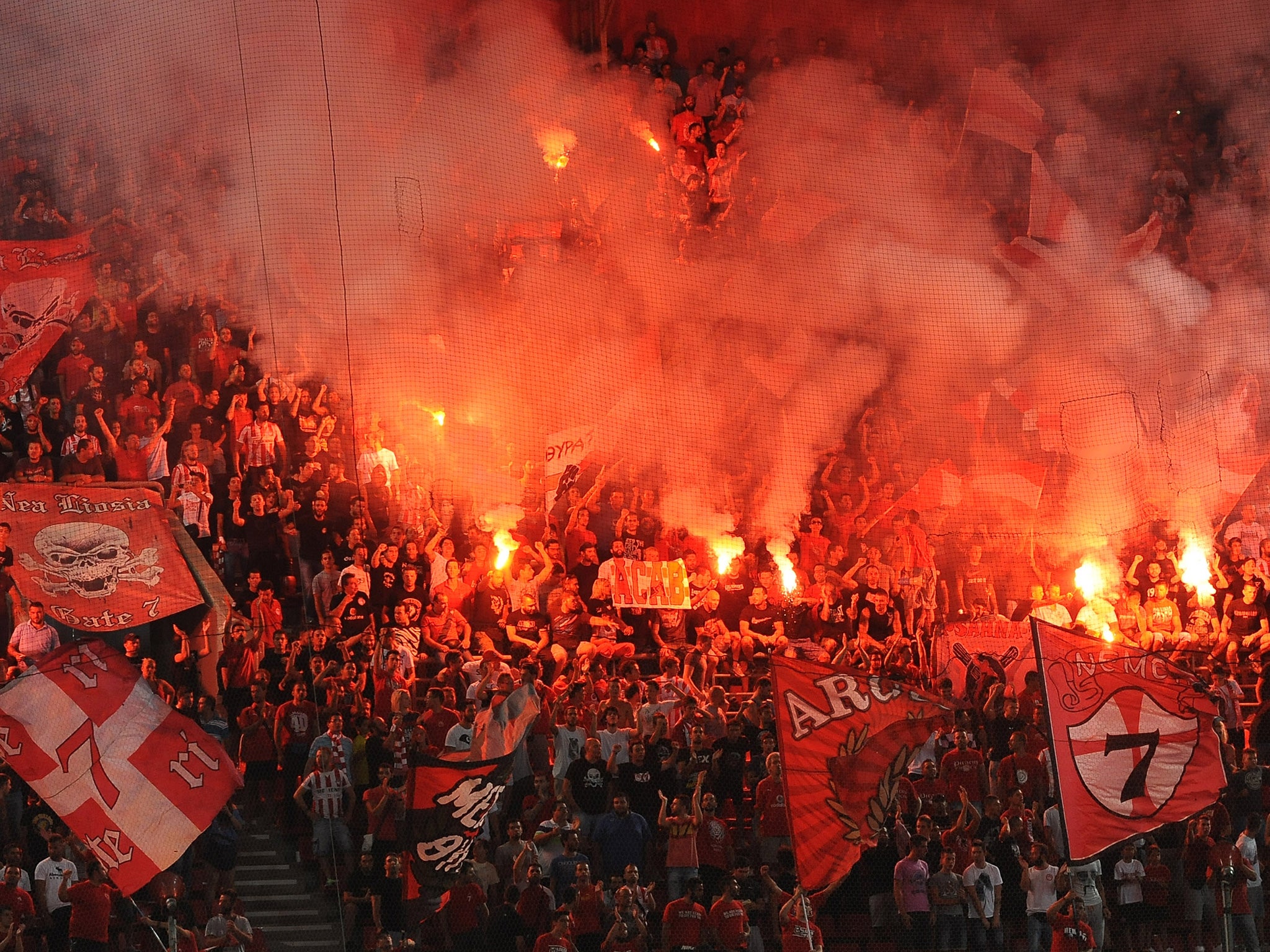 Olympiakos supporters with flares during a match against Atromitos in 2013