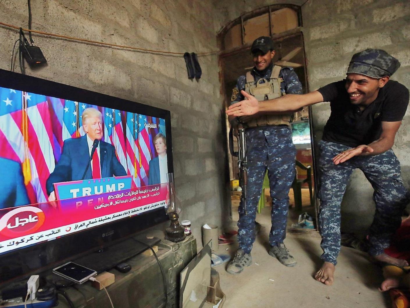 Iraqi troops watch Donald Trump's victory speech outside the Isis-held city of Mosul on Wednesday 9th November (Getty)