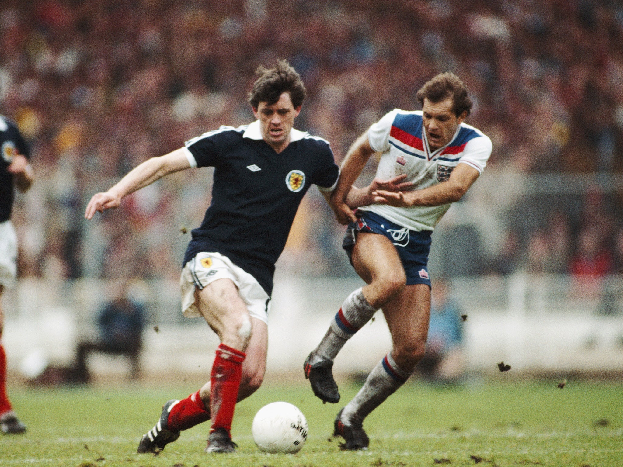 Wilkins tackles David Narey during an England vs Scotland international in 1981