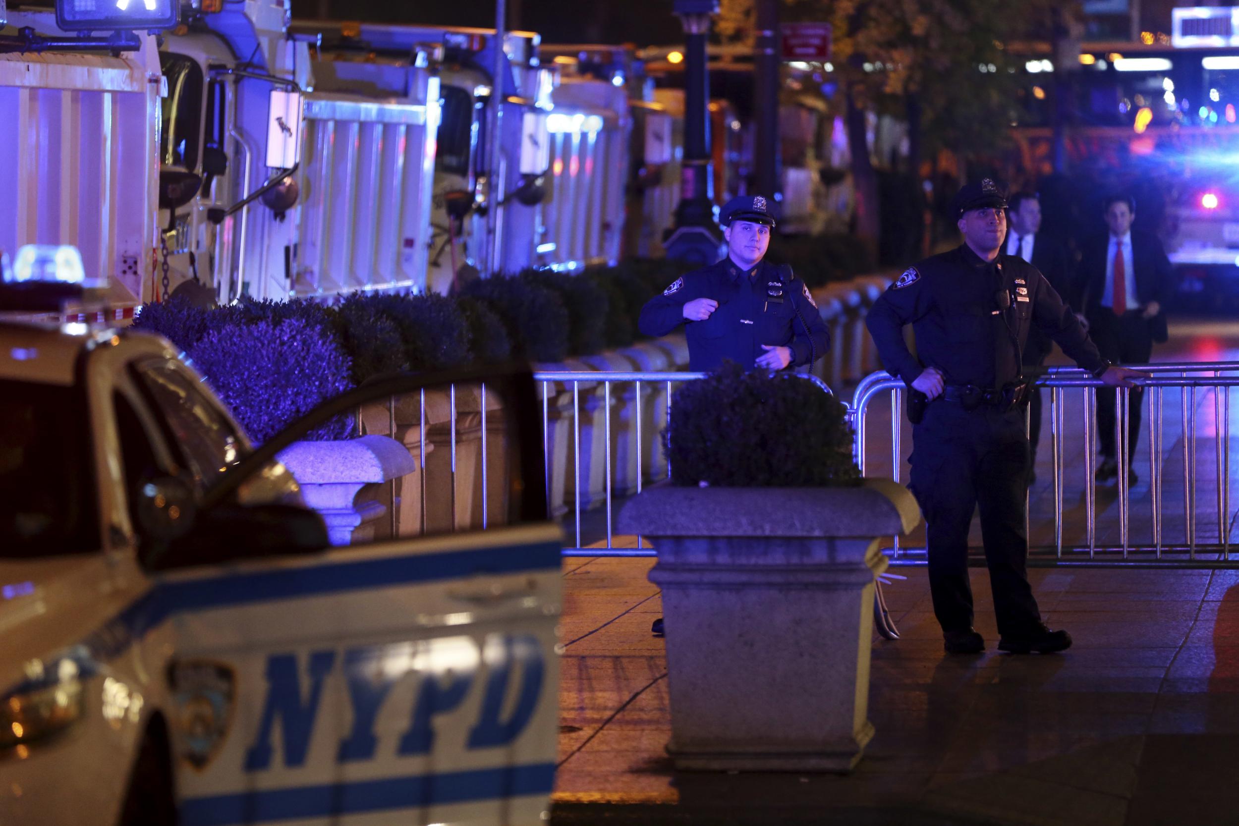 New York City Police and sanitation trucks, block off Trump Tower