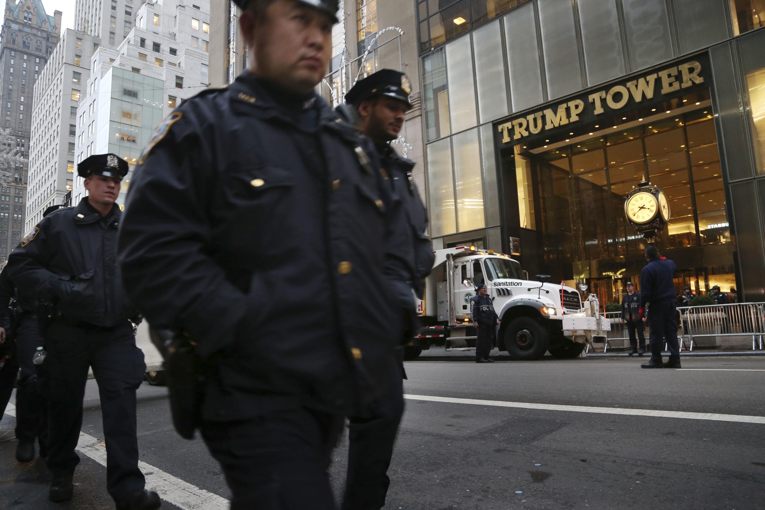 Police officers walk in front of Trump Tower, the home of President-elect Donald Trump