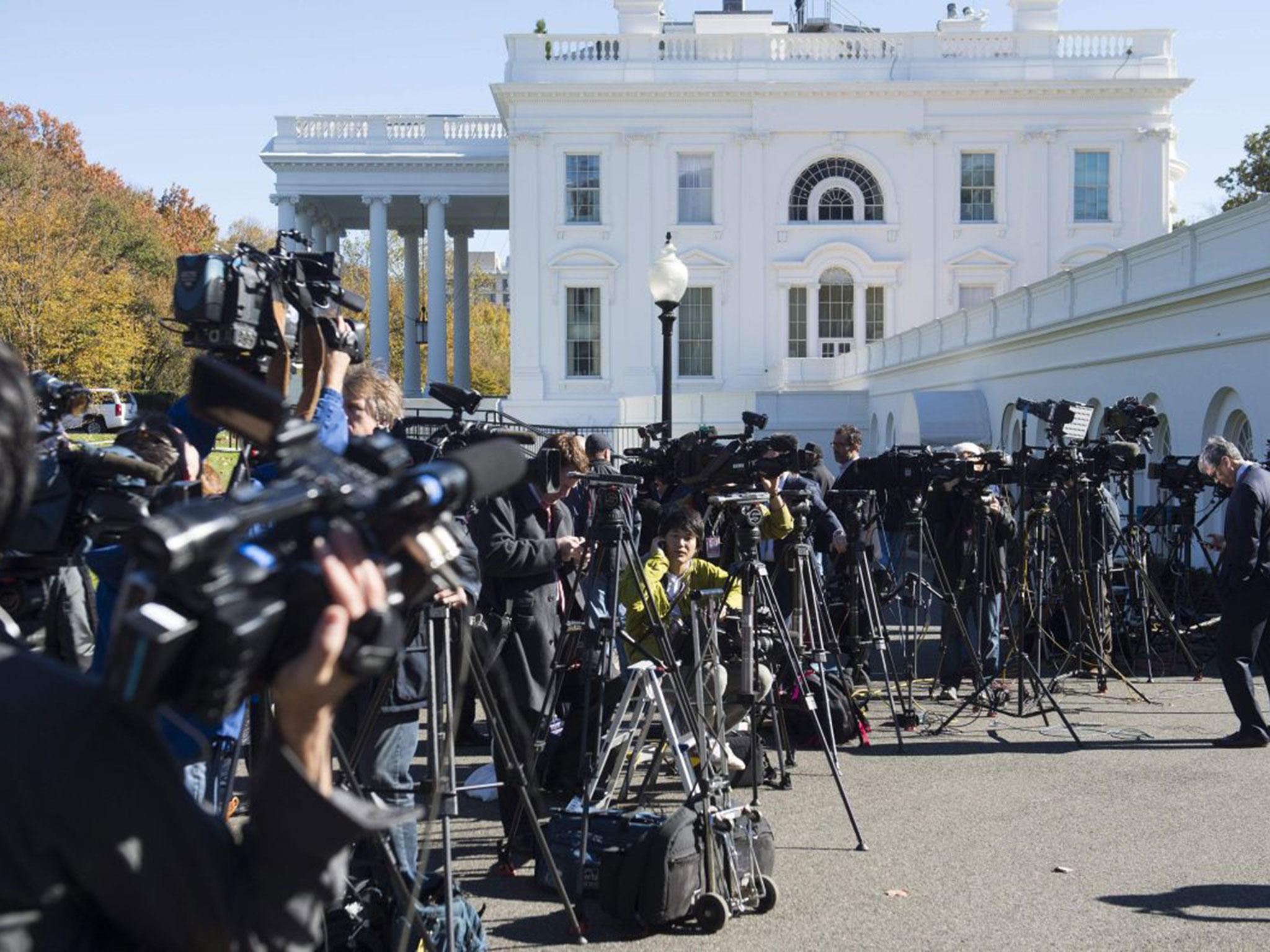 Members of the press await the arrival of US President-elect Donald Trump for a meeting with US President Barack Obama at the White House