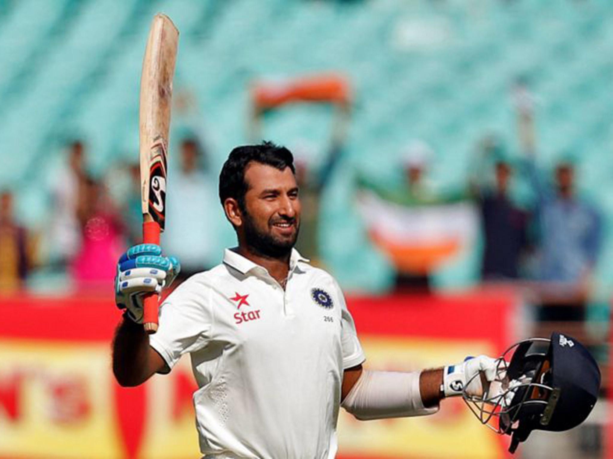 Cheteshwar Pujara celebrates reaching his century in the first Test between India and England